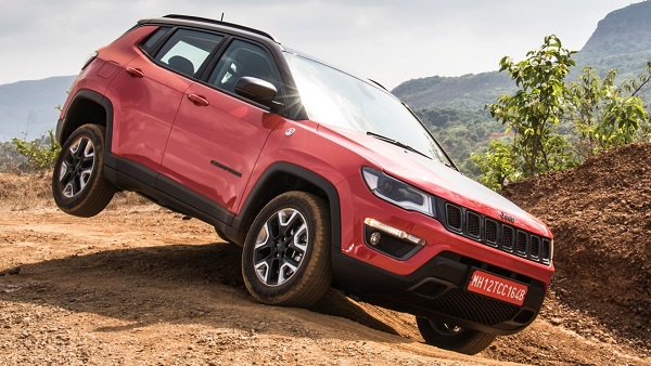 Metallic Red Jeep Compass 4x4 Trail Hawk Compact Crossover SUV On A Rock Surface. 